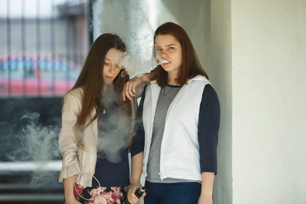 Vape Adolescentes Duas Jovens Meninas Bonitos Roupas Casuais Fumam Cigarros — Fotografia de Stock