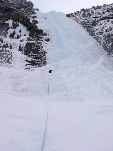 Escalador Hielo Montaña Macho Escalando Una Escarpada Larga Cascada Congelada —  Fotos de Stock