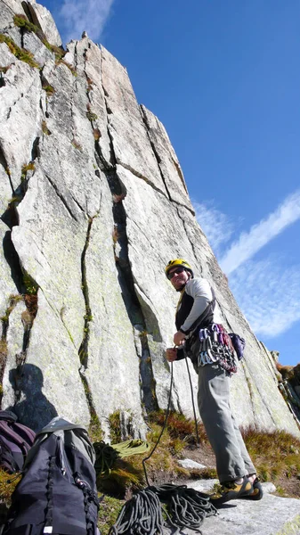 mountain guide rock climber on a steep granite route in the Alps of Switzerland on a beautiful day