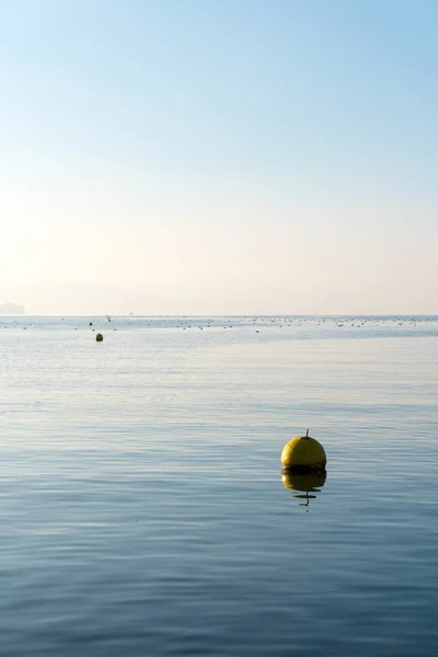 Widok Pionowy Minimalistyczny Jezioro Niebieski Niebo Niebieski Żółty Znacznik Pływających — Zdjęcie stockowe