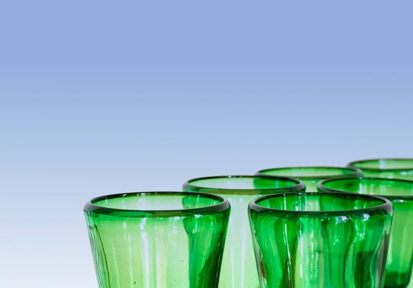 green glass designer wine glasses detail view abstract with copy space horizonal and blue background