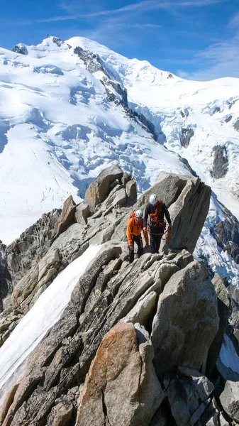 Mountain Guide Male Client Rock Snow Ridge Heading High Summit — Stock Photo, Image