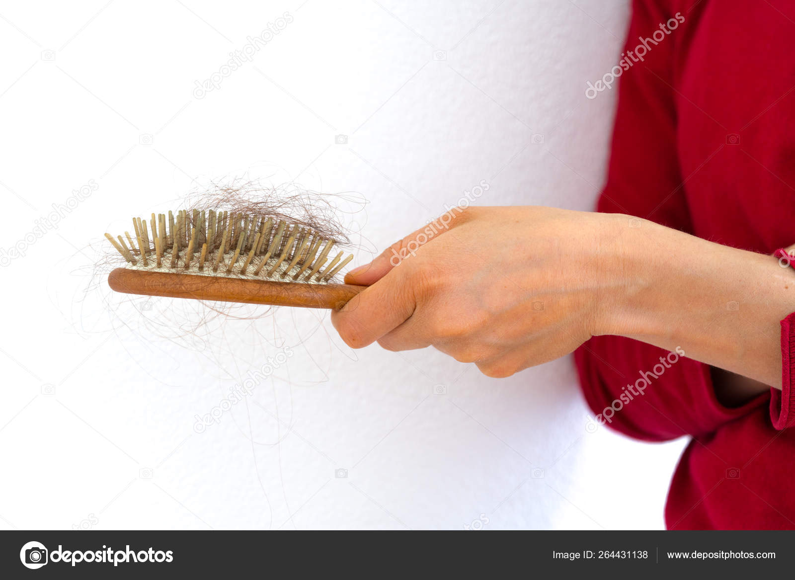 Woman holding wooden hair brush full of hair that has fallen out Stock  Photo by ©makasanaphoto 264431138