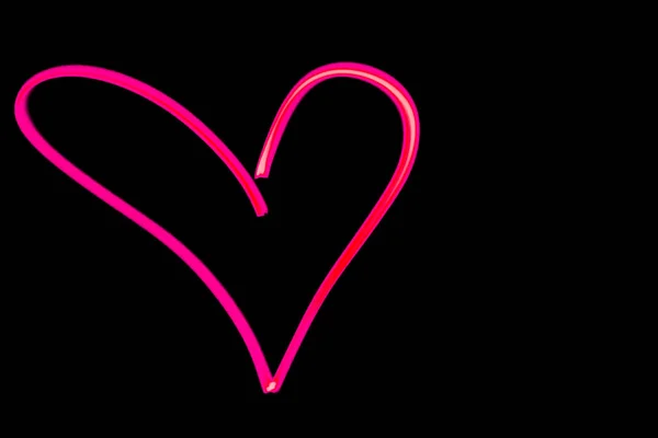 pink heart outline light painting in black night sky