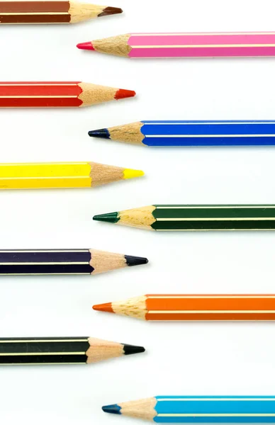 Colored pencils facing each other on a white background Stock Image