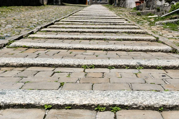 old flat stone stairs leading uphill close up view