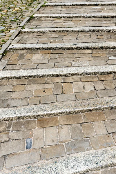 old flat stone stairs leading uphill close up view