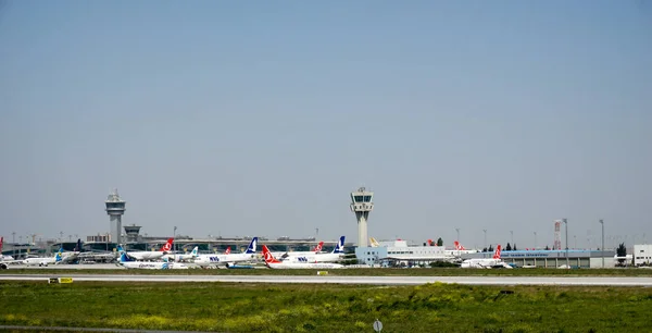 many airplanes at the terminals of the Istanbul airport with con