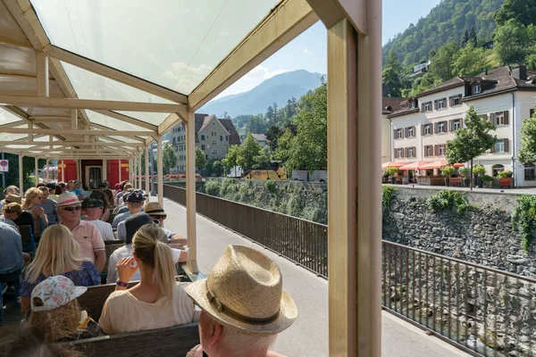 Tourists enjoy traveling in the open panorama train carriage from Chur — Stock Photo, Image