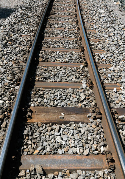 narrow gauge railroad tracks and rock bed close up view