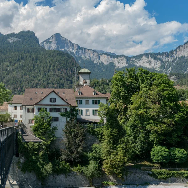 Reichenau Castle and bridge over the Rhine with the Swiss Alps i — Stock Photo, Image