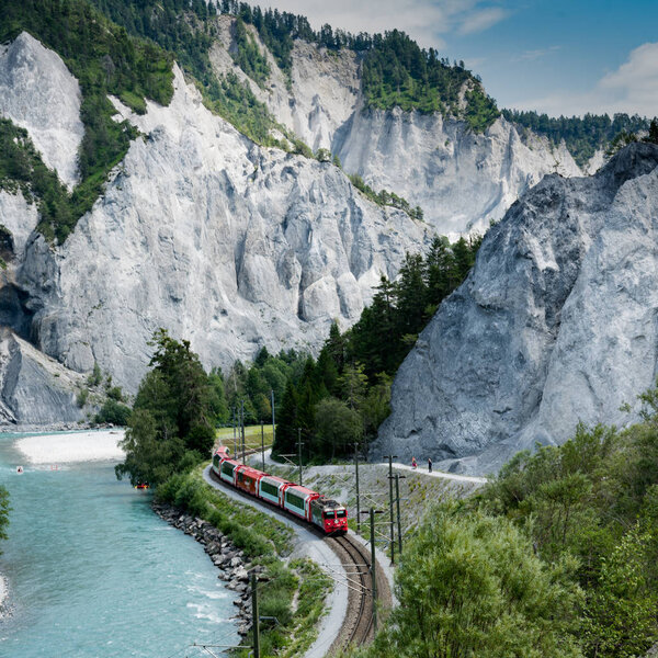 hikers and the Rhaetian railway on the banks of the Rhine River 