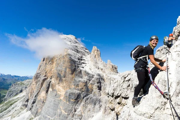 young attractive blonde female mountain climber in the Dolomites