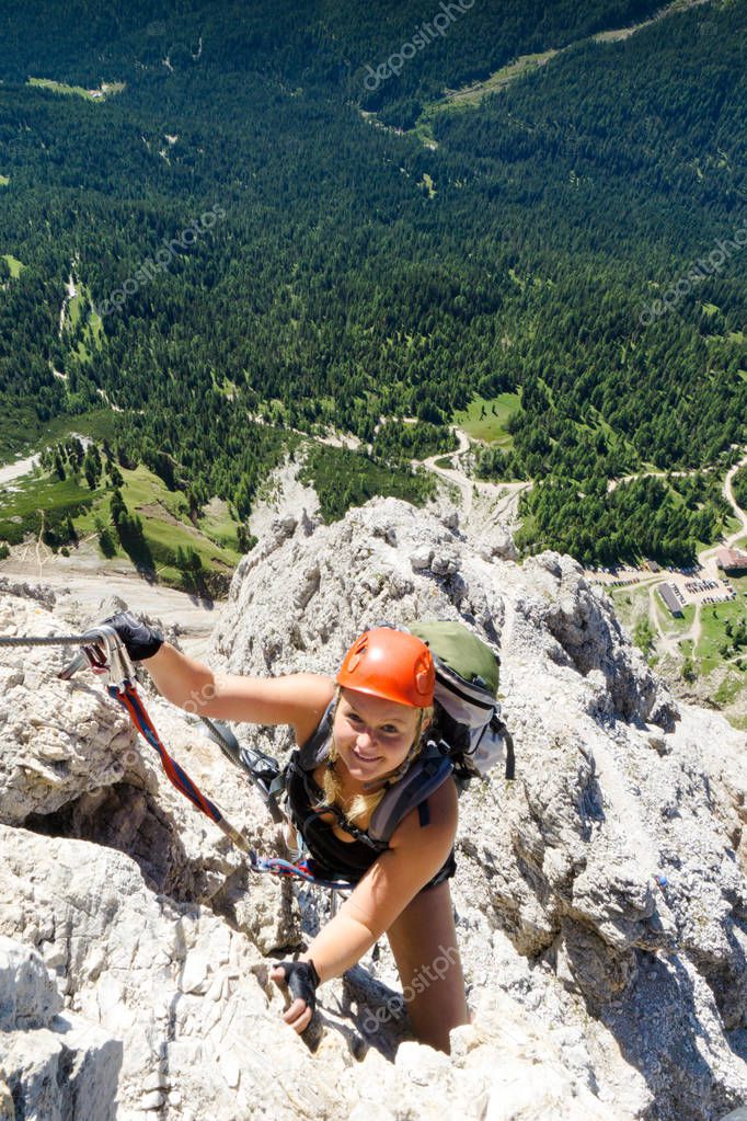 young attractive blonde female mountain climber in the Dolomites