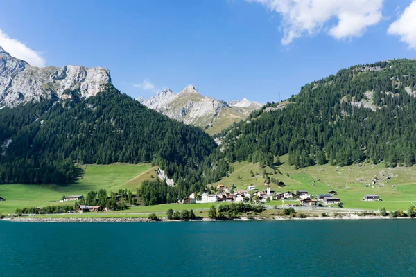 Vista de um idílico e pitoresco lago de montanha turquesa rodeado por floresta verde e picos de montanha nos Alpes Suíços perto de Sufers — Fotografia de Stock