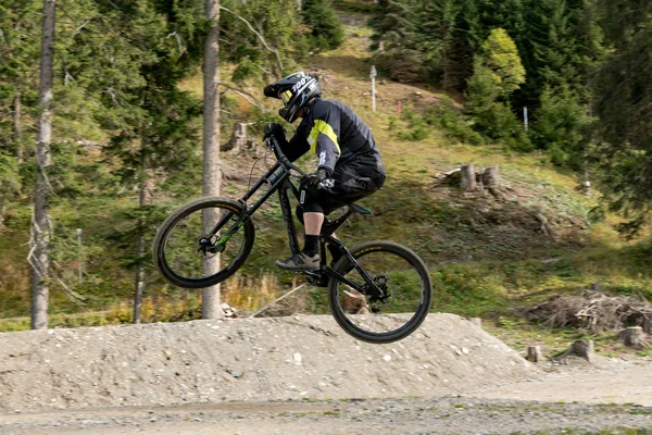 Downhill mountain biker pulando alto e montando duro em Lenzerheide — Fotografia de Stock