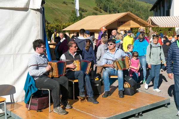 Musical trio playing typical Swiss country music at a village festival — стокове фото