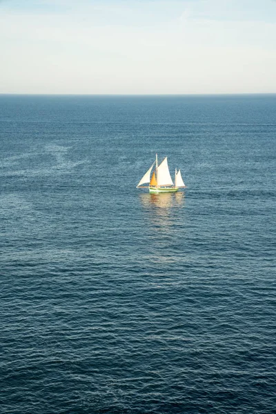 Drewniana żaglówka przepływająca głęboki błękit oceanu — Zdjęcie stockowe