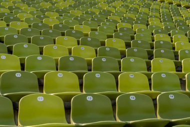 Many endless rows of enpty chairs in a stadium clipart