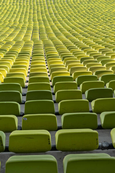 Many endless rows of enpty chairs in a stadium