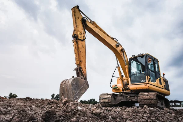 Excavators machine in construction site on sky background