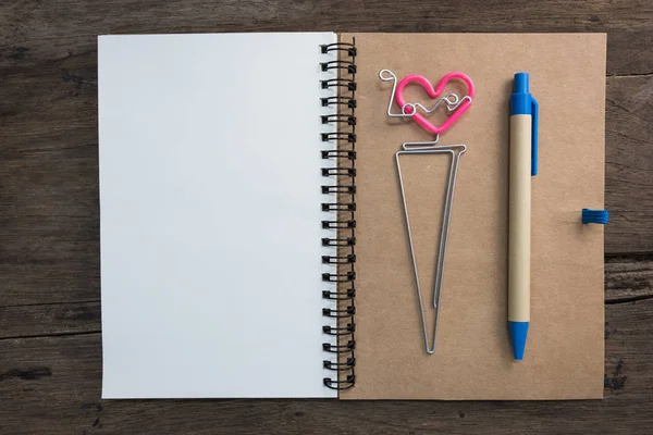 Notebook and pen on wooden table. Backgrounds for text memo in valentine day concept