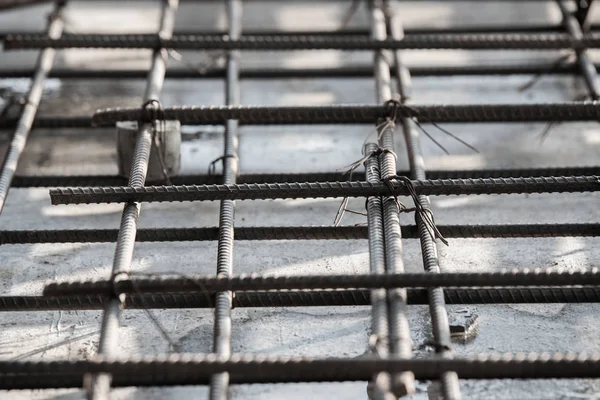 Using steel wire for securing steel bars with wire rod for reinforcement of concrete slab or focus to steel wire.