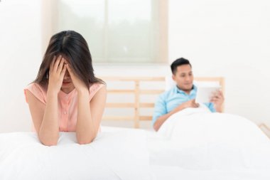 Koca bir tablet sosyal online izlerken yatakta karısının üzgün komik. Bu Smartphone yüz veya Nomophobia Sendromu, Ilişki kavramı sorunu