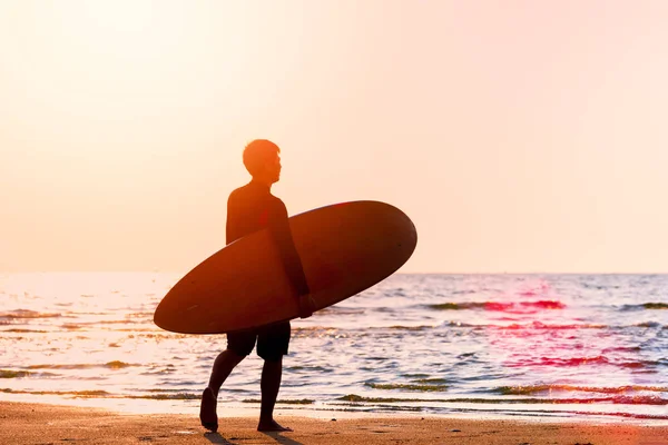 Jovem Segurando Prancha Surf Andando Praia Com Luz Solar Chamas — Fotografia de Stock