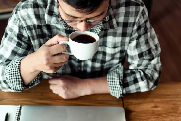 Asian young man drinking coffee in the cafe., How to lifestyle of young asian businessman in the weekend activity relaxing with the coffee. drinking concept.