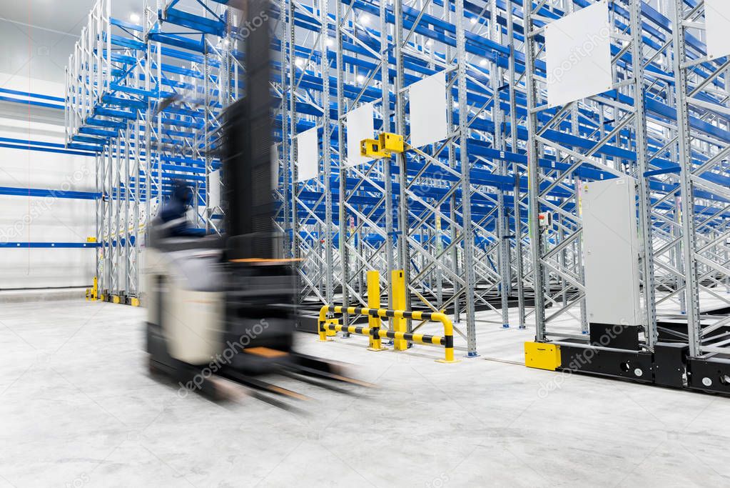 New cold room storage. Refrigeration and freezing warehouse with stacker truck inside moving.