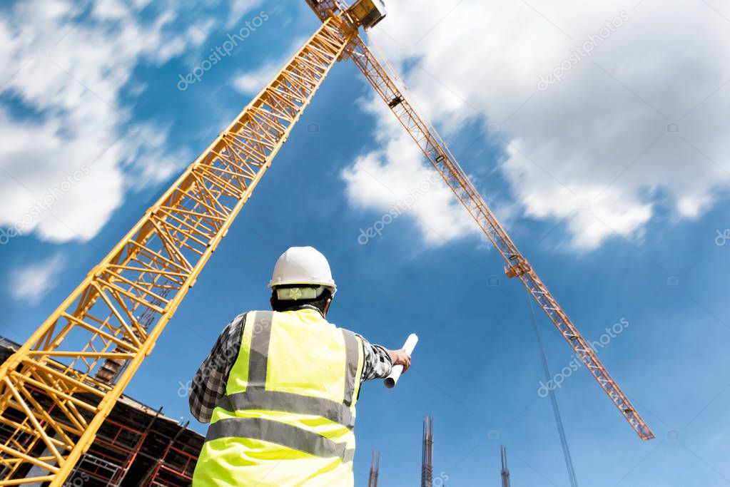 Civil engineer people control and management in the construction site or building site of highrise building