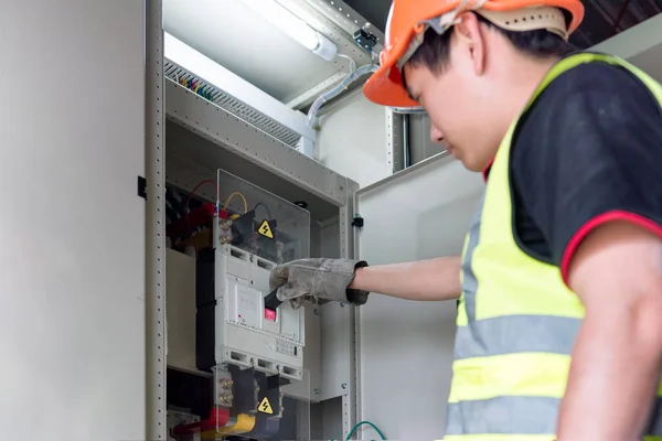 Electrical engineer is shutting the entire electrical system of Main Distribution Board in the control room of plant.