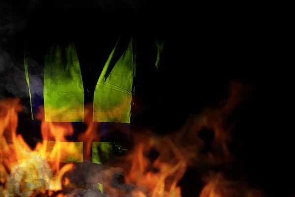 Yellow vests of protest with fire in France on black background.  Protester news concept.