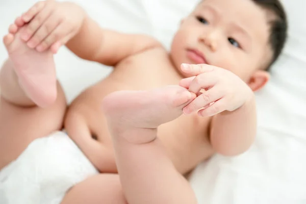 Baby Boy Lying Relaxing Bed White Bedroom Holding His Legs — Stock Photo, Image