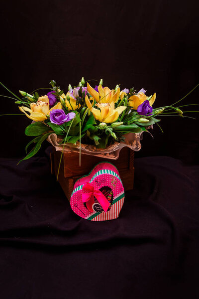 A bouquet of yellow orchids in a tree box