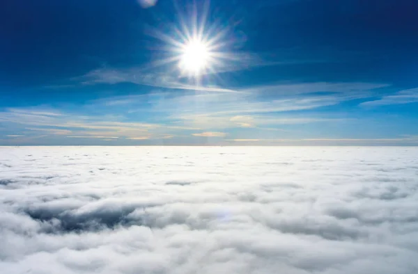 Bright sun over a veil of clouds photo from a paraglider