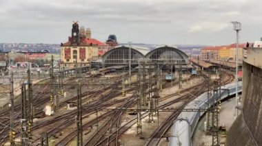 Çek Cumhuriyeti Prag 'daki tren istasyonuna yaklaşan trenin hava görüntüleri. Elektrikli trenler ve tren platformları için sayısız tren yolu ve kablo görebilirsiniz..
