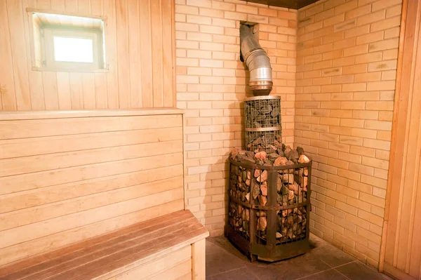 Old stove and stones in the interior of the sauna