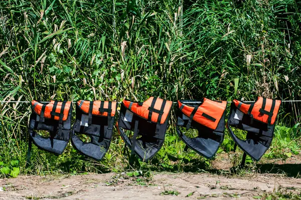 Life Jackets Hang Rope Shore Backdrop Greenery Safe Gear — Stock Photo, Image