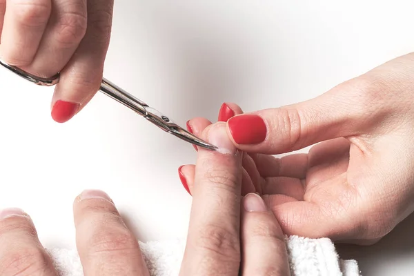 Men's manicure. woman beautician treats cuticles of dry male hands.