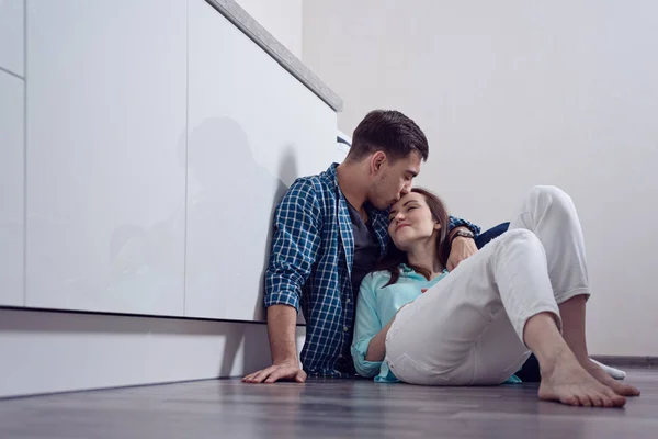 Young Man Kissing Woman Forehead Sitting Floor White Kitchen Relationship — Stock Photo, Image