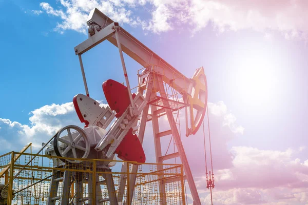 Oil and natural gas production tower with bright sunlight, glare.