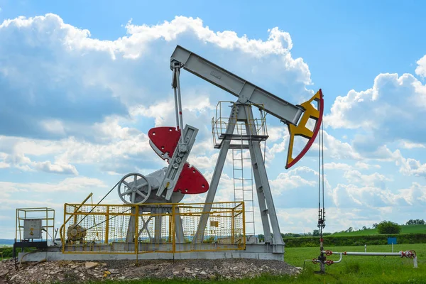 Modern oil rocking chair in a field of green grass