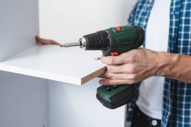 close up of man's hand with screwdriver