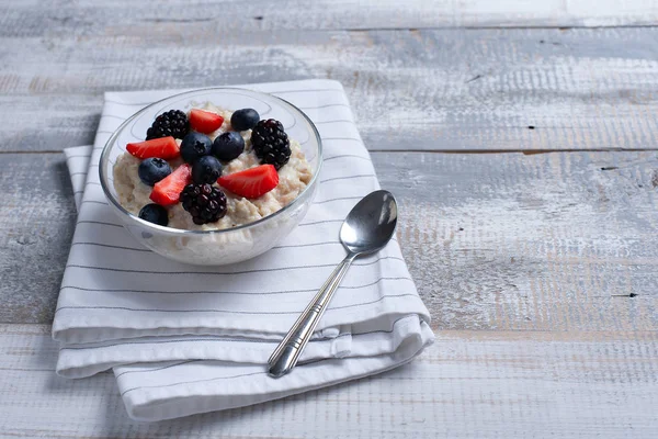 Gesundes Frühstück mit Haferflocken und Beeren auf Holzboden — Stockfoto
