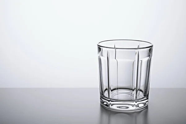 Empty glass glass Cup on the lumen, with a copy of the space