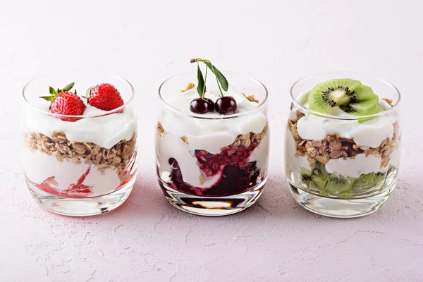 pembe arka plan üzerinde süzme peynir, granola, çilek, kiraz, kivi ile vejetaryen tatlılar