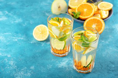 Yaz ferahlatıcı limonata ile portakal, limon, mavi arka planda nane şekeri