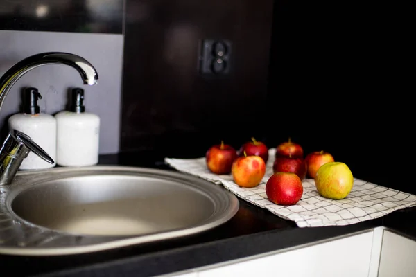 many apples at home near the sink lie on a towel and dried, wash with tap water fruits for hygiene, a cozy home style